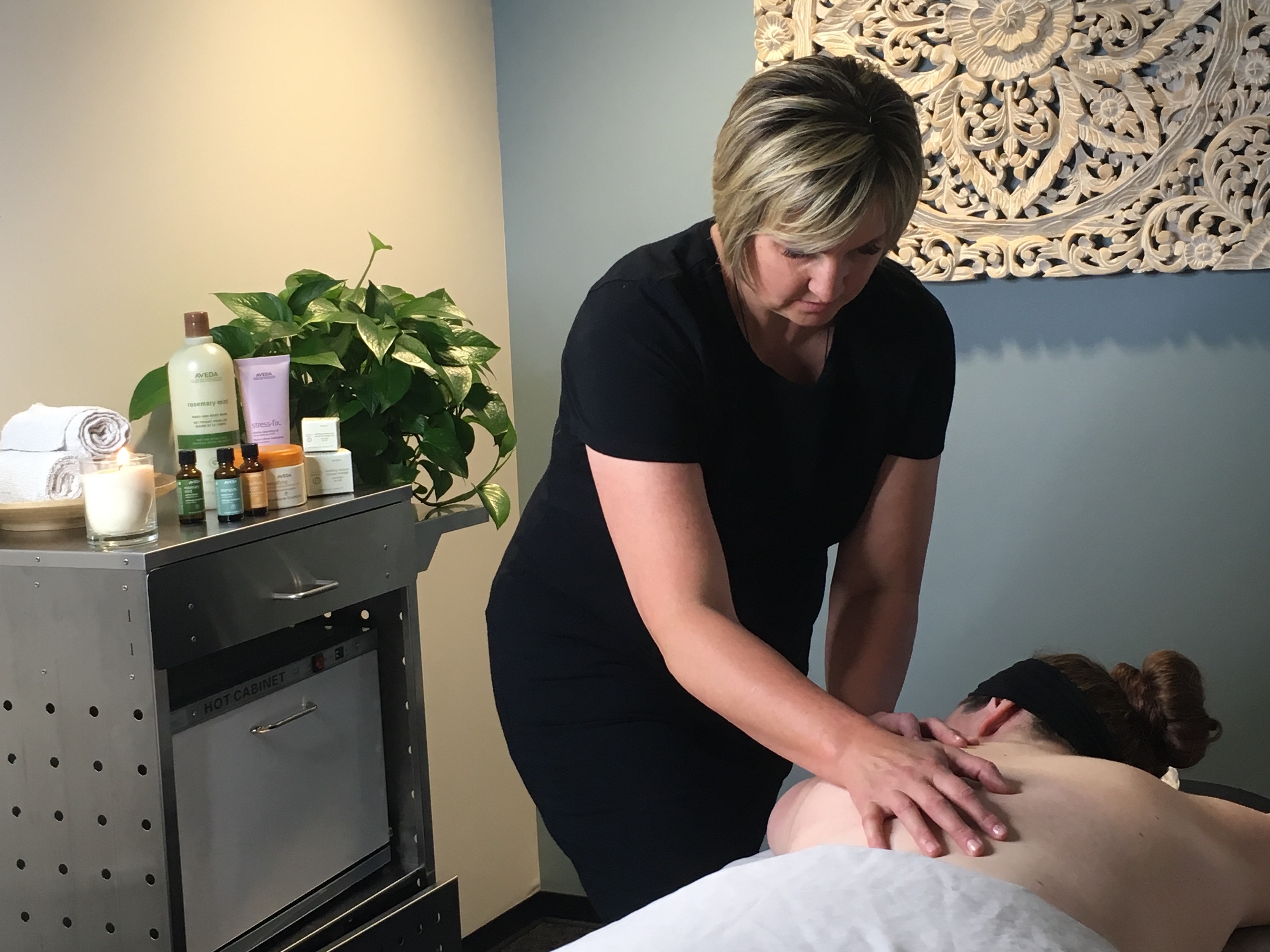 A massage therapist providing massage services