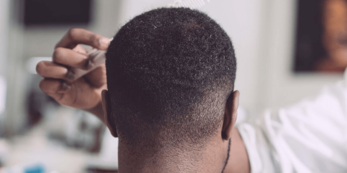 Man getting a fade haircut at the barbershop.
