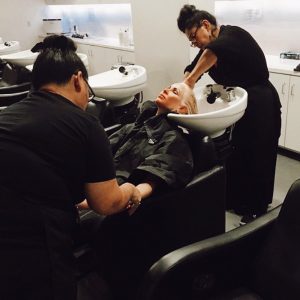 Cosmetology Students Washing Performing Salon Services for Woman