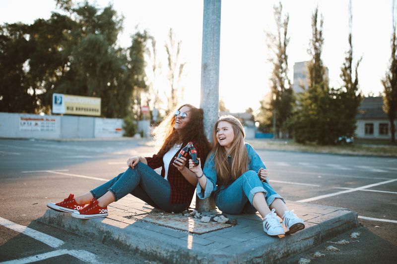 girls laughing in a parking lot