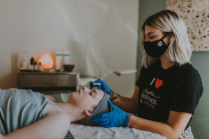 Inspire Greatness Aveda Institutes Esthiology student performing facial on client