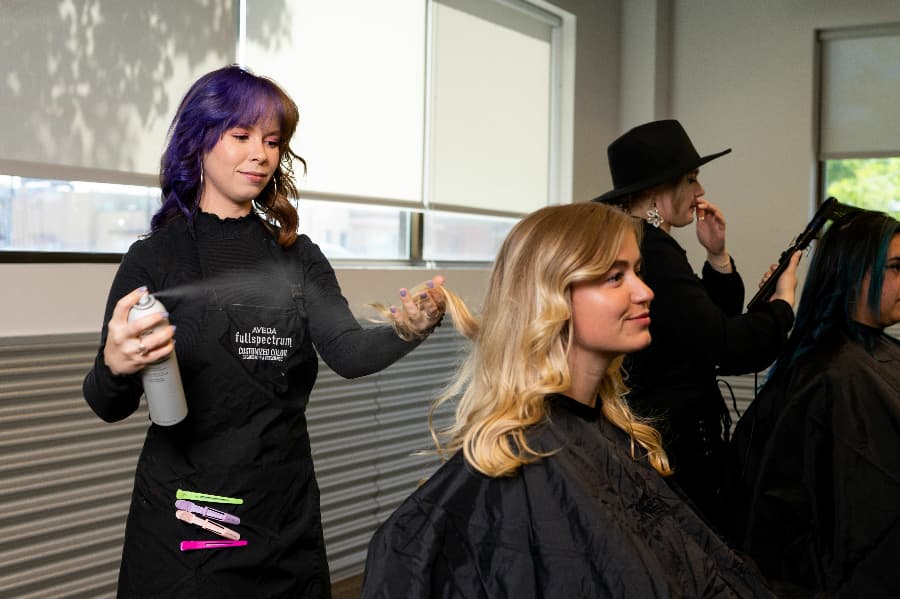 aveda institute student styling hair