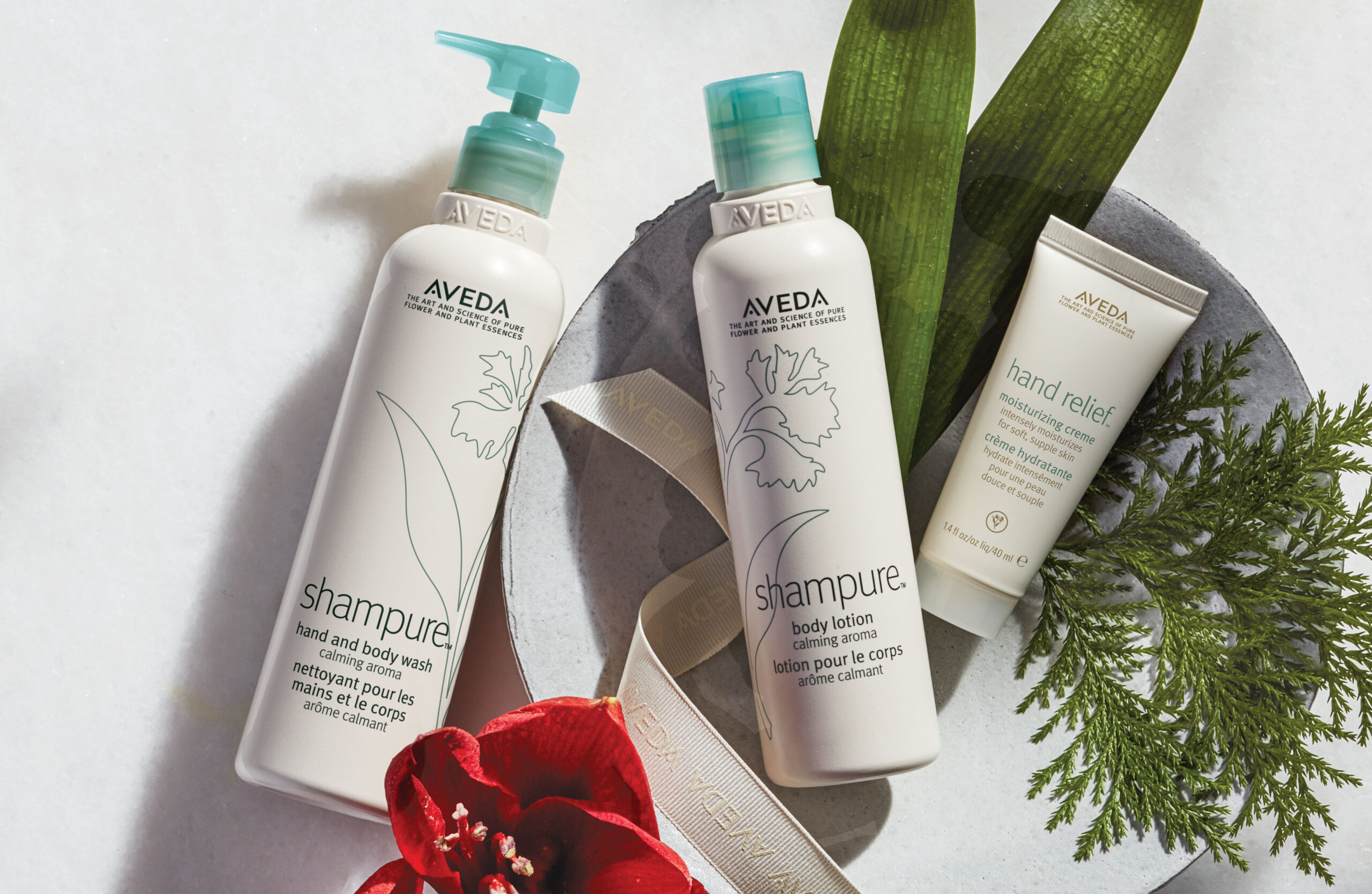 Aveda bottles on display with flowers