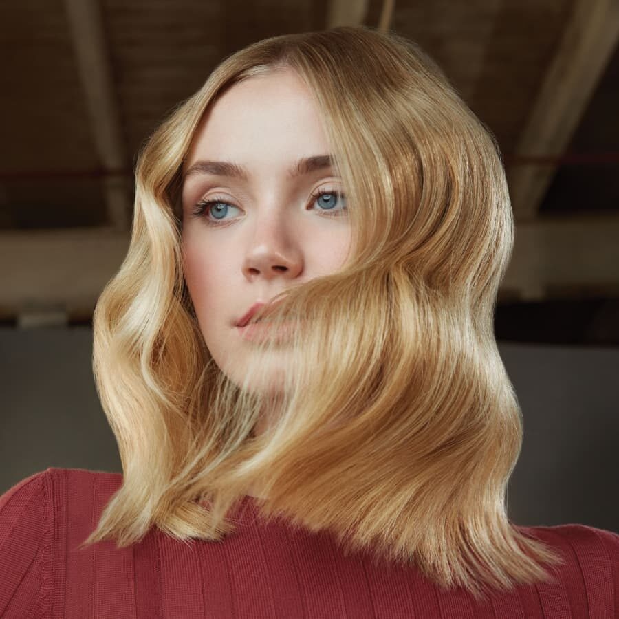 Aveda model with wavy shoulder length blonde hair