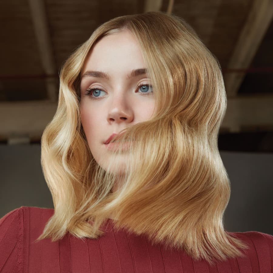 Aveda model with wavy shoulder length blonde hair