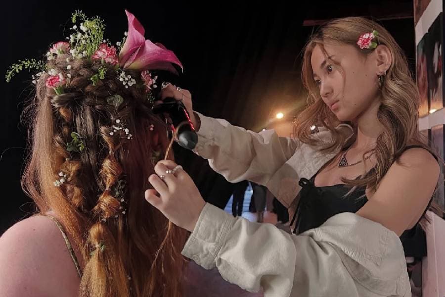 aveda stylist styles hair with flowers