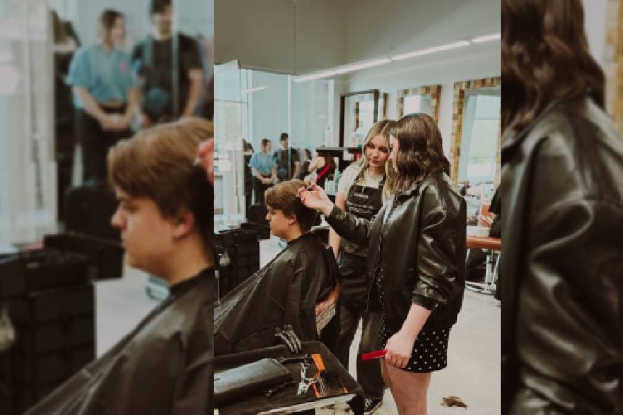 student barber cutting clients hair